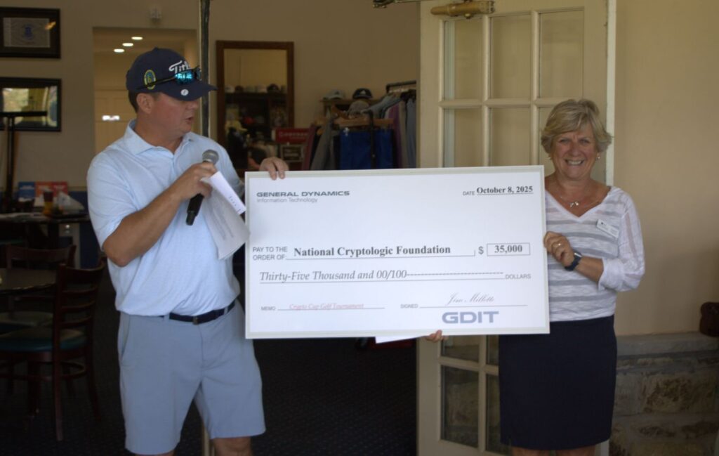GDIT's Jim Millette presents the tournament check to NCF CEO Laura Nelson at the 2025 Crypto Cup