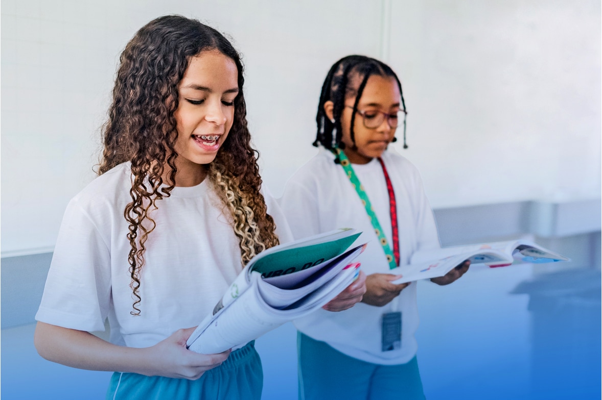 two young girls giving oral presentation of written works