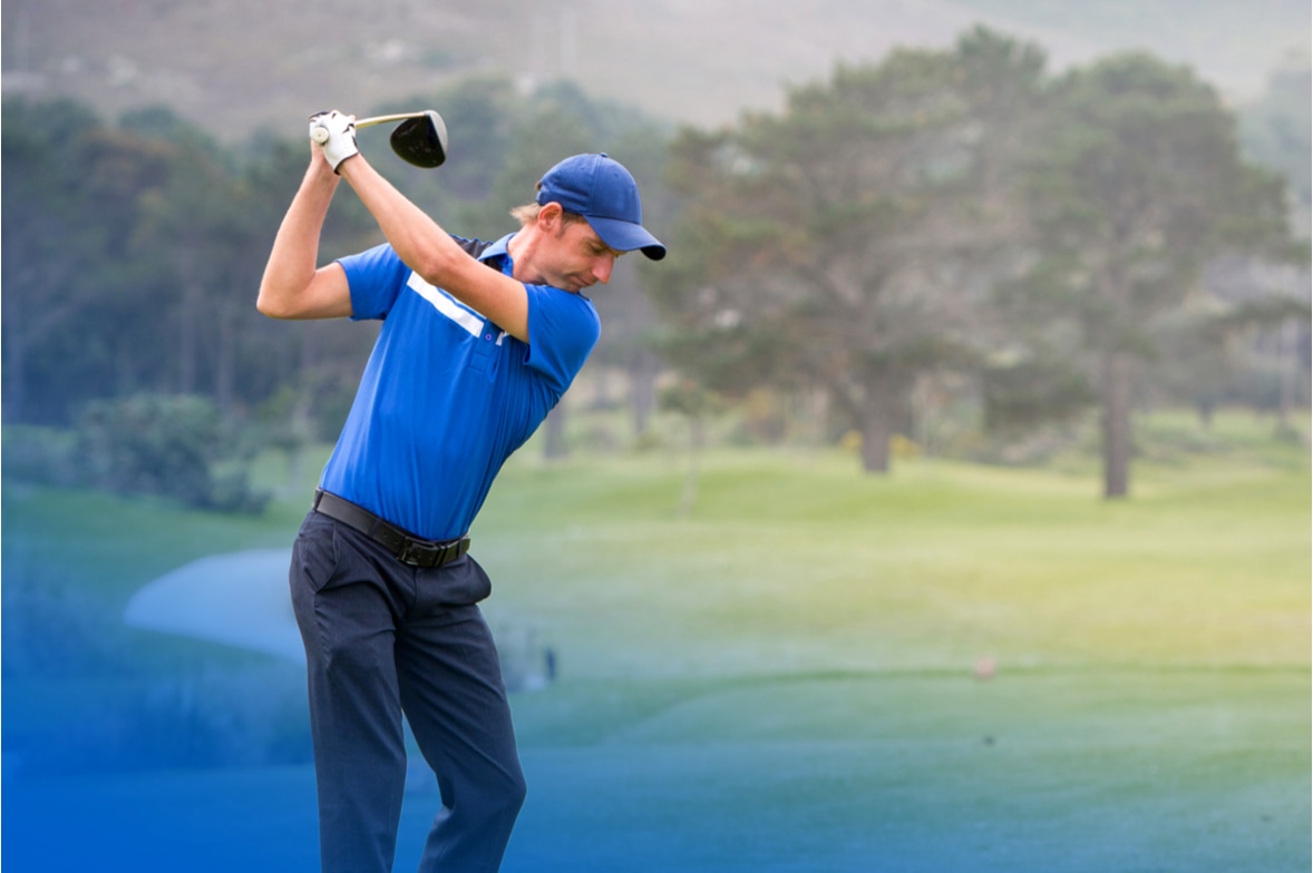 golfer takes tee shot at golf tournament