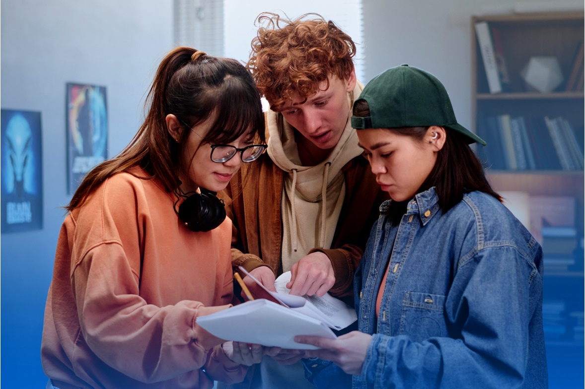 three teen students deciphering escape room clues