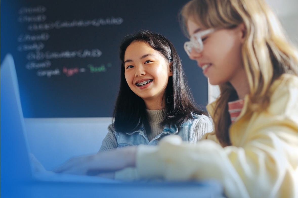 two girls use classroom computer