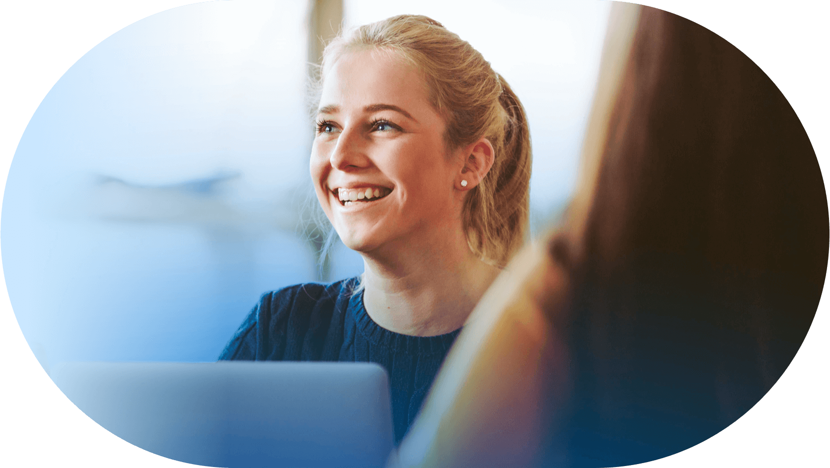 young woman smiling in office meeting frame 1@2x